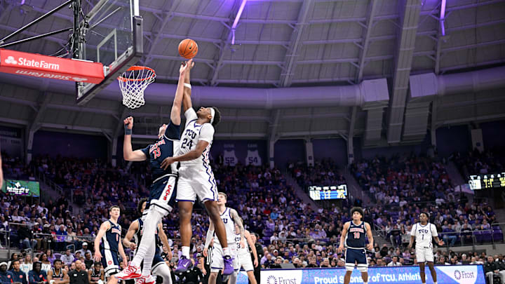 Jan 10, 2026; Fort Worth, Texas, USA; Arizona Wildcats center Motiejus Krivas (13) and TCU Horned Frogs forward Xavier Edmonds (24) jump for the rebound during the first half at the Ed and Rae Schollmaier Arena. Mandatory Credit: Jerome Miron-Imagn Images