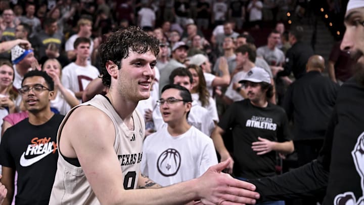 Feb 18, 2026; College Station, Texas, USA; Texas A&M Aggies guard Rubén Dominguez (9) high-fives teammate guard Pop Isaacs (2) after the game against the Ole Miss Rebels at Reed Arena. Mandatory Credit: Maria Lysaker-Imagn Images 