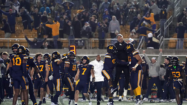 Nov 29, 2025; Berkeley, California, USA; California Golden Bears players and coaches celebrate after a missed field goal by the Southern Methodist Mustangs during the fourth quarter at California Memorial Stadium. Mandatory Credit: Darren Yamashita-Imagn Images Nov 29, 2025; Berkeley, California, USA; California Golden Bears players and coaches celebrate after a missed field goal by the Southern Methodist Mustangs during the fourth quarter at California Memorial Stadium. Mandatory Credit: Darren Yamashita-Imagn Images