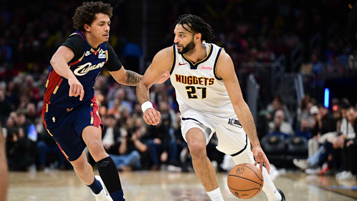 Jan 2, 2026; Cleveland, Ohio, USA; Denver Nuggets guard Jamal Murray (27) drives on Cleveland Cavaliers guard Craig Porter Jr. (9) during the second half at Rocket Arena. Mandatory Credit: David Dermer-Imagn Images