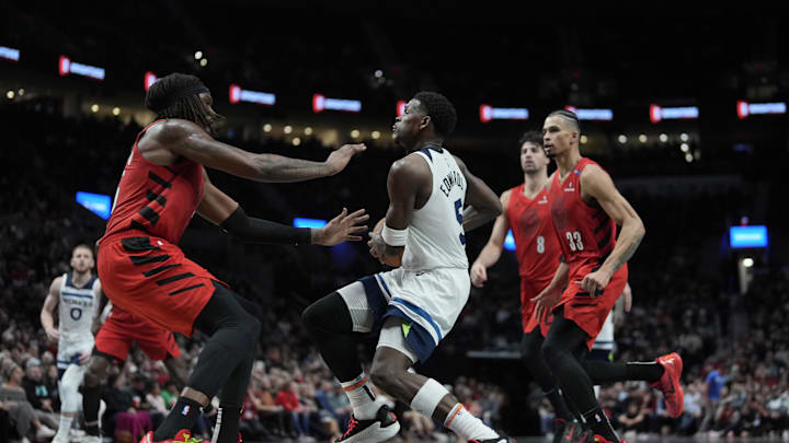Nov 12, 2024; Portland, Oregon, USA; Minnesota Timberwolves shooting guard Anthony Edwards (5) drives to the basket against Portland Trail Blazers center Robert Williams III (35, left) during the second half at Moda Center. Mandatory Credit: Soobum Im-Imagn Images