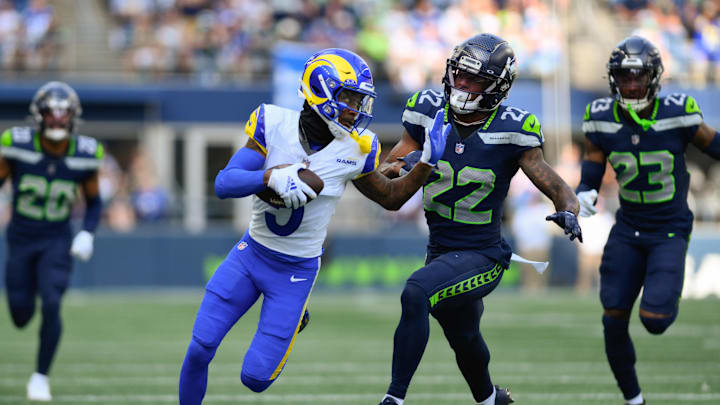Sep 10, 2023; Seattle, Washington, USA; Los Angeles Rams wide receiver Tutu Atwell (5) carries the ball after a catch while Seattle Seahawks cornerback Tre Brown (22) chases during the second half at Lumen Field. Mandatory Credit: Steven Bisig-Imagn Images