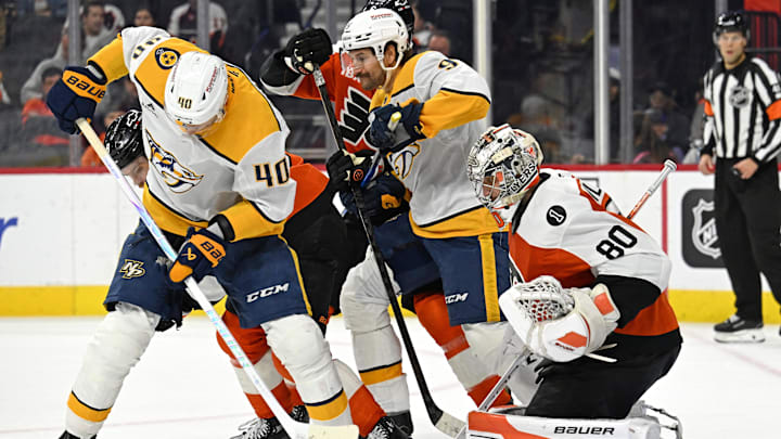 Oct 30, 2025; Philadelphia, Pennsylvania, USA; Nashville Predators center Fedor Svechkov (40) tries to control the puck in front of Philadelphia Flyers goaltender Dan Vladar (80) during the second period at Xfinity Mobile Arena. Mandatory Credit: Eric Hartline-Imagn Images