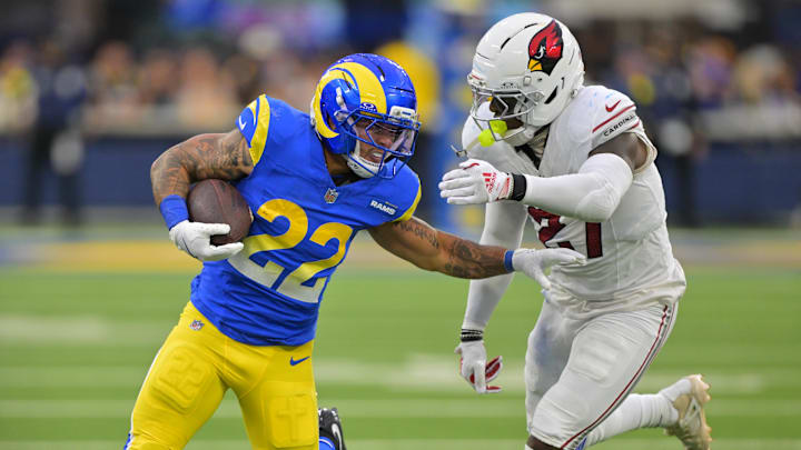 Jan 4, 2026; Inglewood, California, USA;  Los Angeles Rams running back Blake Corum (22) carries the ball as Arizona Cardinals linebacker Akeem Davis-Gaither (27) defends during the second half at SoFi Stadium. Mandatory Credit: Jayne Kamin-Oncea-Imagn Images