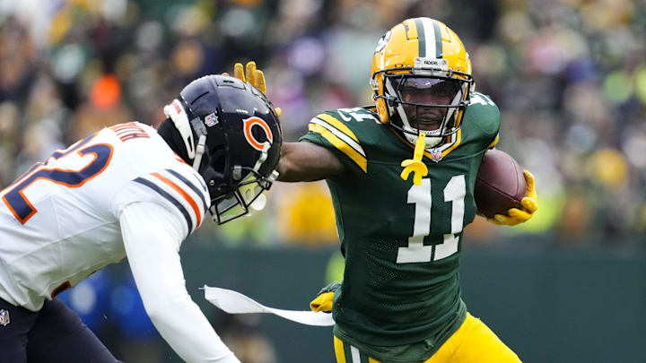 Jan 5, 2025; Green Bay, Wisconsin, USA; Green Bay Packers wide receiver Jayden Reed (11) stiff arms Chicago Bears safety Elijah Hicks (22) during the fourth quarter at Lambeau Field. Mandatory Credit: Jeff Hanisch-Imagn Images Jan 5, 2025; Green Bay, Wisconsin, USA; Green Bay Packers wide receiver Jayden Reed (11) stiff arms Chicago Bears safety Elijah Hicks (22) during the fourth quarter at Lambeau Field. Mandatory Credit: Jeff Hanisch-Imagn Images