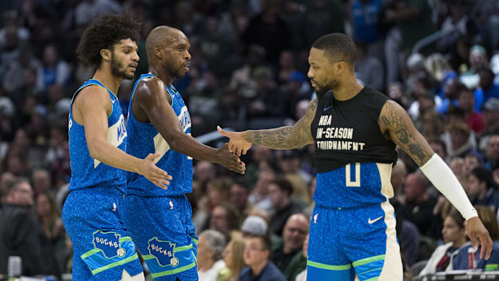 Nov 24, 2023; Milwaukee, Wisconsin, USA;  Milwaukee Bucks guard Damian Lillard (0) celebrates with forward Khris Middleton (22) and guard Andre Jackson Jr. (44) during the second quarter at Fiserv Forum. Mandatory Credit: Jeff Hanisch-Imagn Images