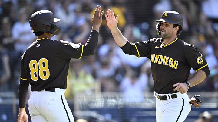 San Diego Padres catcher Ethan Salas (88) celebrates with third baseman Graham Pauley (right) after scoring runs against the Seattle Mariners during the seventh inning at Petco Park on March 26, 2024.