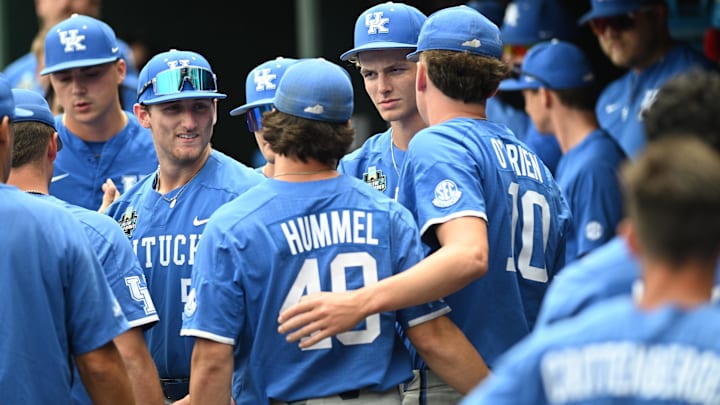 Jun 19, 2024; Omaha, NE, USA;  Kentucky Wildcats pitcher Johnny Hummel (49) and pitcher Cameron O'Brien (10) and teammates gather after the loss against the Florida Gators at Charles Schwab Field Omaha. Mandatory Credit: Steven Branscombe-Imagn Images