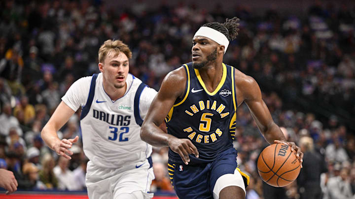 Oct 29, 2025; Dallas, Texas, USA; Indiana Pacers forward Jarace Walker (5) moves the ball past Dallas Mavericks forward Cooper Flagg (32) during the second quarter at the American Airlines Center. Mandatory Credit: Jerome Miron-Imagn Images