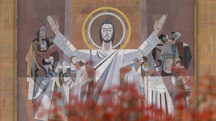 Nov 8, 2025; South Bend, Indiana, USA; The World of Life Mural, commonly known as Touchdown Jesus, on the Hesburgh Library with fall foliage before the Notre Dame Fighting Irish vs. the Navy Midshipmen logos at Notre Dame Stadium. Mandatory Credit: Michael Caterina-Imagn Images