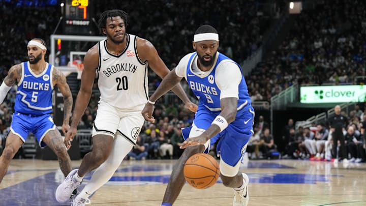 Dec 26, 2024; Milwaukee, Wisconsin, USA;  Milwaukee Bucks forward Bobby Portis (9) reaches for the loose ball in front of Brooklyn Nets center Day'Ron Sharpe (20) during the third quarter at Fiserv Forum. Mandatory Credit: Jeff Hanisch-Imagn Images