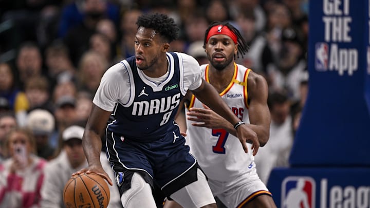 Feb 12, 2025; Dallas, Texas, USA; Dallas Mavericks forward Olivier-Maxence Prosper (8) and Golden State Warriors guard Buddy Hield (7) in action during the game between the Dallas Mavericks and the Golden State Warriors at the American Airlines Center. Mandatory Credit: Jerome Miron-Imagn Images