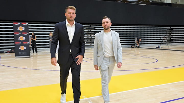 Aug 2, 2025; El Segundo, CA, USA; Los Angeles Lakers Luka Doncic (77) walks with team communications director Mitch Heckart following a press conference announcing the signing of a 3-year, $165 million contract extension at UCLA Health Training Center. Mandatory Credit: Jayne Kamin-Oncea-Imagn Images