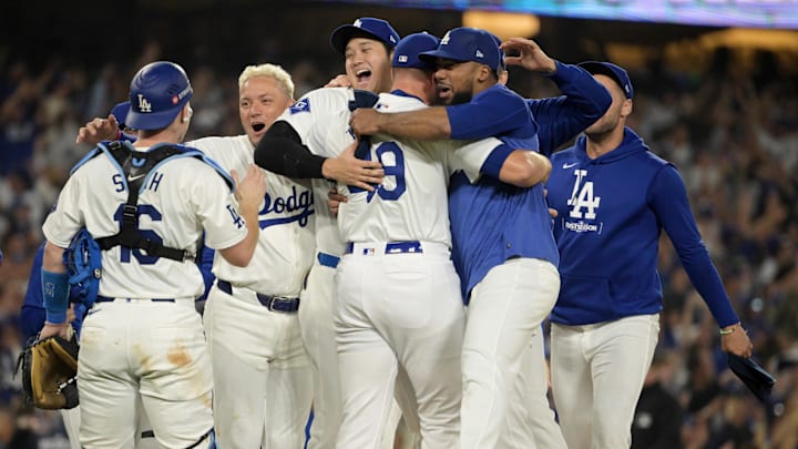 Oct 11, 2024; Los Angeles, California, USA; Los Angeles Dodgers pitcher Blake Treinen (49) and designated hitter Shohei Ohtani (17) and outfielder Teoscar Hernandez (37) celebrate with teammates after defeating the San Diego Padres during game five of the NLDS for the 2024 MLB Playoffs at Dodger Stadium. Mandatory Credit: Jayne Kamin-Oncea-Imagn Images