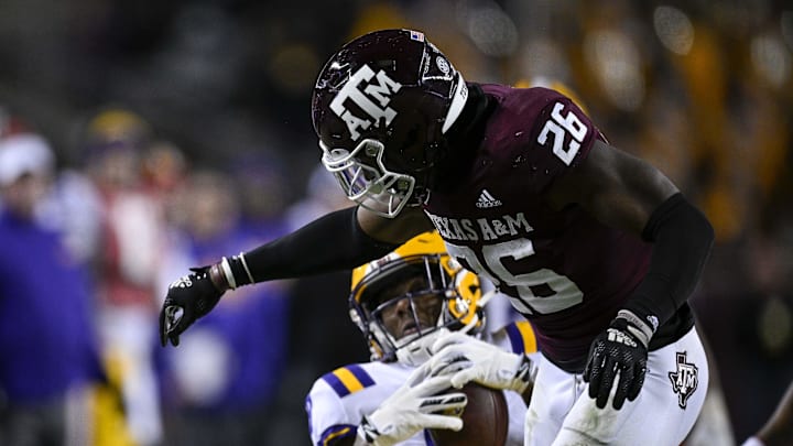 Nov 26, 2022; College Station, Texas, USA; Texas A&M Aggies defensive back Demani Richardson (26) hits LSU Tigers wide receiver Malik Nabers (8) after he makes the catch during the second half at Kyle Field. Mandatory Credit: Jerome Miron-Imagn Images
