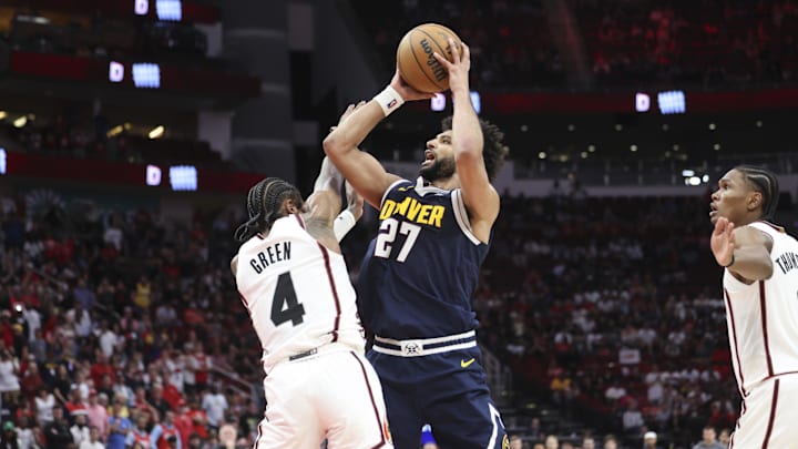 Mar 23, 2025; Houston, Texas, USA; Denver Nuggets guard Jamal Murray (27) attempts to shoot the ball as Houston Rockets guard Jalen Green (4) defends during the fourth quarter at Toyota Center. Mandatory Credit: Troy Taormina-Imagn Images