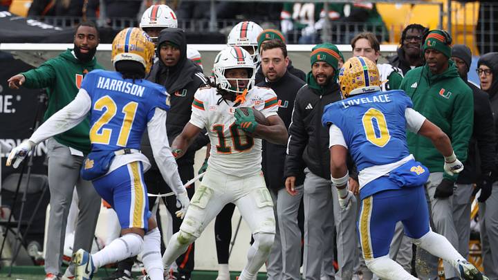 Nov 29, 2025; Pittsburgh, Pennsylvania, USA; Miami Hurricanes wide receiver Malachi Toney (10) runs after a catch as Pittsburgh Panthers defensive back Shadarian Harrison (21) and linebacker Braylan Lovelace (0) defend during the fourth quarter at Acrisure Stadium. Mandatory Credit: Charles LeClaire-Imagn Images Nov 29, 2025; Pittsburgh, Pennsylvania, USA; Miami Hurricanes wide receiver Malachi Toney (10) runs after a catch as Pittsburgh Panthers defensive back Shadarian Harrison (21) and linebacker Braylan Lovelace (0) defend during the fourth quarter at Acrisure Stadium. Mandatory Credit: Charles LeClaire-Imagn Images