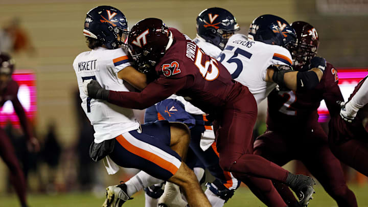 Nov 30, 2024; Blacksburg, Virginia, USA; Virginia Tech Hokies defensive lineman Antwaun Powell-Ryland (52) sacks Virginia Cavaliers quarterback Tony Muskett (7) during the first quarter at Lane Stadium. Mandatory Credit: Peter Casey-Imagn Images