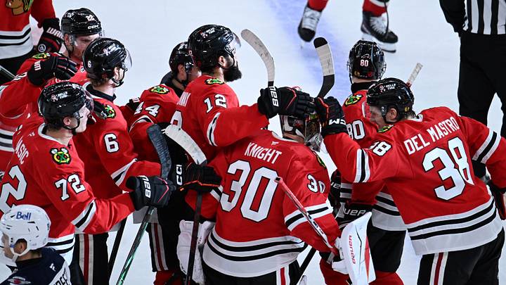 Oct 15, 2026; Chicago, Illinois, USA;  Chicago Blackhawks players celebrates with goalie Spencer Knight (30) after the overtime period against the Winnipeg Jets at the United Center.  Mandatory Credit: Matt Marton-Imagn Images