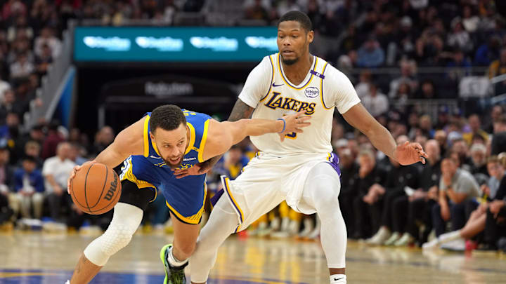 Dec 25, 2024; San Francisco, California, USA; Golden State Warriors guard Stephen Curry (left) dribbles against Los Angeles Lakers forward Cam Reddish (right) during the fourth quarter at Chase Center. Mandatory Credit: Darren Yamashita-Imagn Images Dec 25, 2024; San Francisco, California, USA; Golden State Warriors guard Stephen Curry (left) dribbles against Los Angeles Lakers forward Cam Reddish (right) during the fourth quarter at Chase Center. Mandatory Credit: Darren Yamashita-Imagn Images