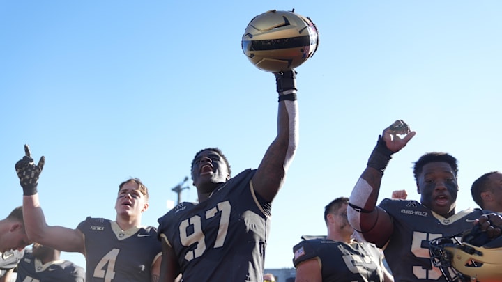 Army defensive lineman Dre Miller (97) and wide receiver Liam Fortner (4) celebrate after a game this season.
