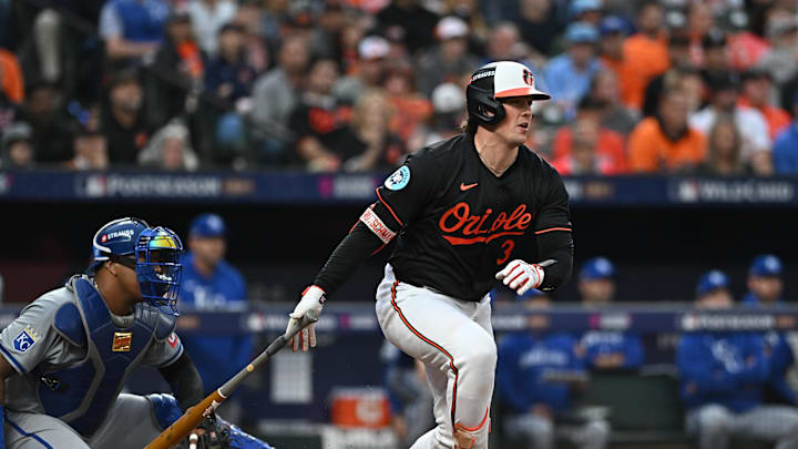 Oct 2, 2024; Baltimore, Maryland, USA; Baltimore Orioles catcher Adley Rutschman (35) hits a single against the Kansas City Royals in the fourth inning in game two of the Wild Card round for the 2024 MLB Playoffs at Oriole Park at Camden Yards. 