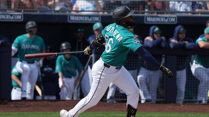 Feb 26, 2026; Peoria, Arizona, USA; Seattle Mariners left fielder Randy Arozarena (56) hits an RBI double against the Cleveland Guardians in the first inning at Peoria Sports Complex. Mandatory Credit: Rick Scuteri-Imagn Images