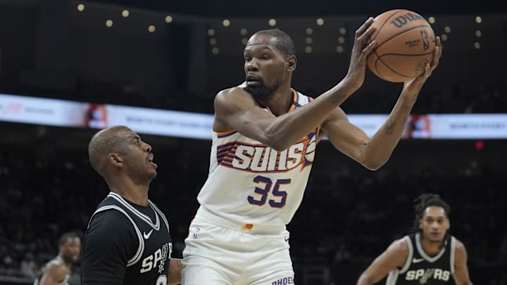 Feb 20, 2025; Austin, Texas, USA; Phoenix Suns forward Kevin Durant (35) looks to drive to the basket while defended by San Antonio Spurs guard Chris Paul (3) during the first half at Moody Center. Mandatory Credit: Scott Wachter-Imagn Images