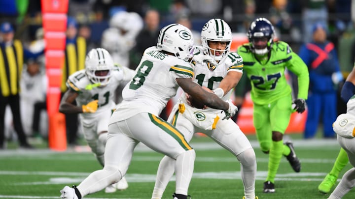 Green Bay Packers quarterback Jordan Love (10) hands the ball off to running back Josh Jacobs at Seattle. Green Bay Packers quarterback Jordan Love (10) hands the ball off to running back Josh Jacobs at Seattle.