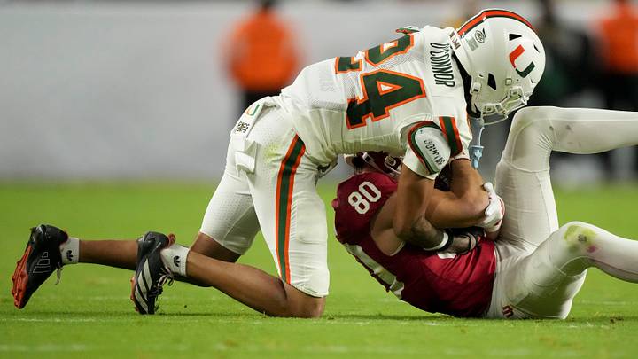 Indiana Hoosiers wide receiver Charlie Becker (80) makes a catch while being guarded by Miami (FL) Hurricanes defensive back Ethan O'Connor (24) on Monday, Jan. 19, 2026, during the College Football Playoff National Championship college football game at Hard Rock Stadium in Miami Gardens.