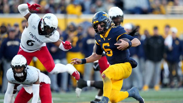 West Virginia Mountaineers quarterback Garrett Greene (6) carries the ball on a touchdown run in the third quarter during an NCAA college football game between the Cincinnati Bearcats and the West Virginia Mountaineers, Saturday, Nov. 18, 2023, at Milan Puskar Stadium in Morgantown, W. Va. The West Virginia Mountaineers won, 42-21.