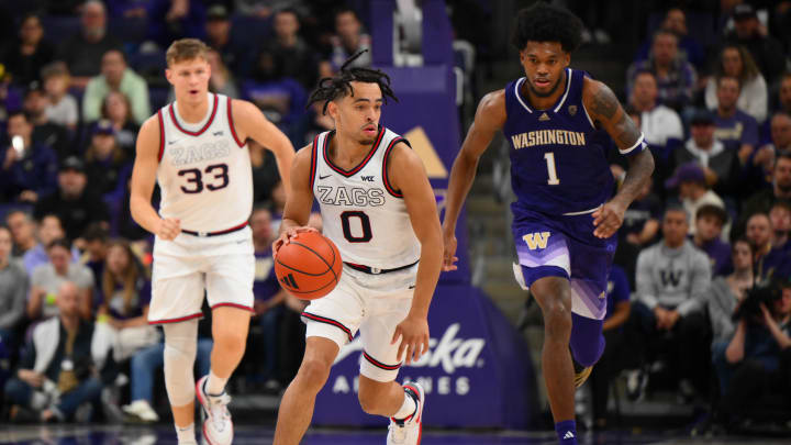 Dec 9, 2023; Seattle, Washington, USA; Gonzaga Bulldogs guard Ryan Nembhard (0) dribbles the ball while chased by Washington Huskies forward Keion Brooks Jr. (1) during the game at Alaska Airlines Arena at Hec Edmundson Pavilion. Mandatory Credit: Steven Bisig-USA TODAY Sports