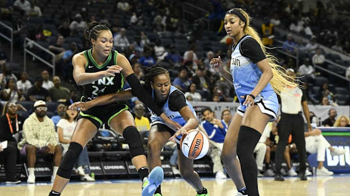 Jul 14, 2025; Chicago, Illinois, USA;  Chicago Sky guard Ariel Atkins (7) grabs the ball from Minnesota Lynx forward Napheesa Collier (24) as  forward Angel Reese (5) looks on during the first half at Wintrust Arena. Mandatory Credit: Matt Marton-Imagn Images
