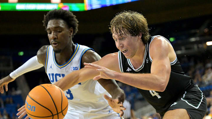 Dec 19, 2025; Los Angeles, California, USA; Cal Poly Mustangs guard Kieran Elliott (4) looses control of the ball as he is defended by UCLA Bruins guard Eric Dailey Jr. (3) during the second half at Pauley Pavilion presented by Wescom Financial. Mandatory Credit: Jayne Kamin-Oncea-Imagn Images