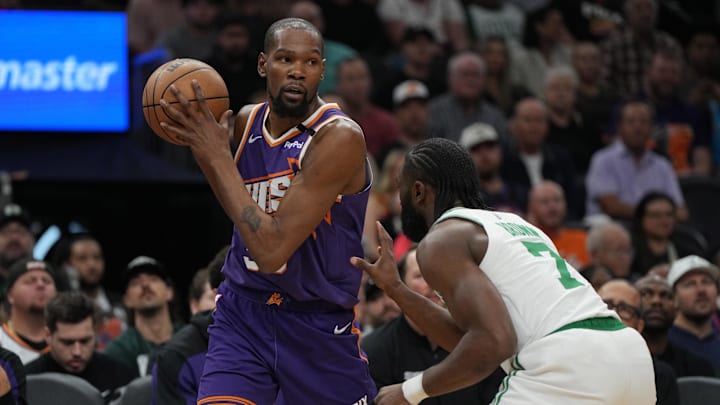 Mar 26, 2025; Phoenix, Arizona, USA; Phoenix Suns forward Kevin Durant (35) shields the ball from Boston Celtics guard Jaylen Brown (7) during the first half at Footprint Center. Mandatory Credit: Rick Scuteri-Imagn Images