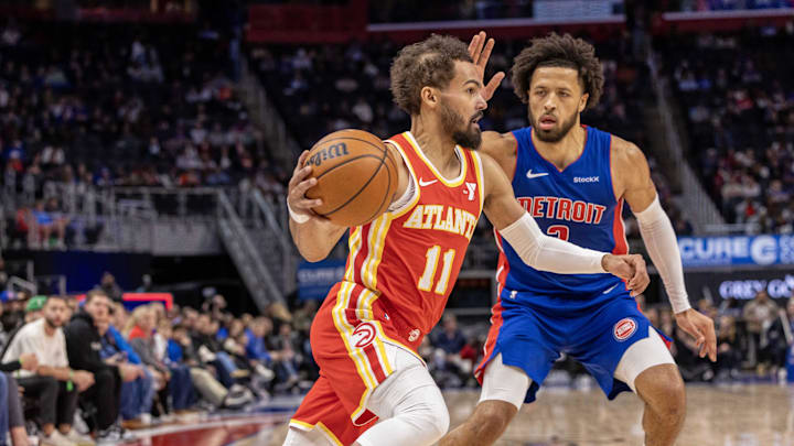 Nov 8, 2024; Detroit, Michigan, USA; Atlanta Hawks guard Trae Young (11) moves the ball up court next to Detroit Pistons guard Cade Cunningham (2) during the first half at Little Caesars Arena. Mandatory Credit: David Reginek-Imagn Images