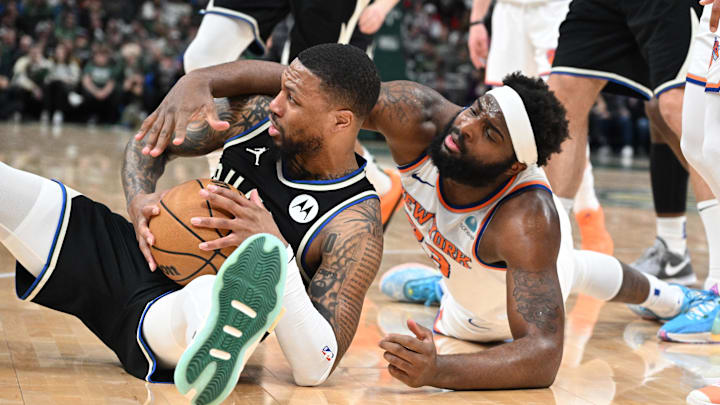 Apr 7, 2024; Milwaukee, Wisconsin, USA; Milwaukee Bucks guard Damian Lillard (0) and New York Knicks center Mitchell Robinson (23) battle for a loose ball in the first half at Fiserv Forum. Mandatory Credit: Michael McLoone-Imagn Images Apr 7, 2024; Milwaukee, Wisconsin, USA; Milwaukee Bucks guard Damian Lillard (0) and New York Knicks center Mitchell Robinson (23) battle for a loose ball in the first half at Fiserv Forum. Mandatory Credit: Michael McLoone-Imagn Images