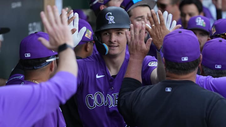 Colorado Rockies right fielder Mickey Moniak (22) celebrates with teammates after hitting a solo home run.