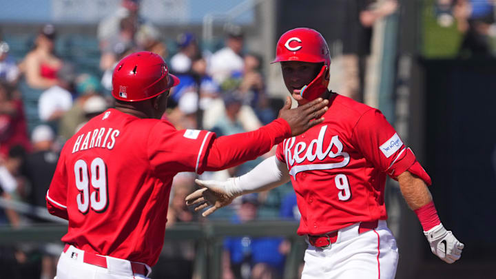 Mar 5, 2026; Goodyear, Arizona, USA; Cincinnati Reds second baseman Matt McLain (9) slaps hands with Cincinnati Reds third base coach Willie Harris (99) after hitting a home run against the Los Angeles Dodgers during the second inning at Goodyear Ballpark. Mandatory Credit: Joe Camporeale-Imagn Images
