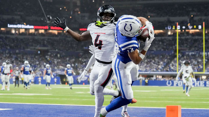 Indianapolis Colts wide receiver Alec Pierce (14) makes a catch in front of Houston Texans cornerback Kamari Lassiter (4) for a touchdown Sunday, Nov. 30, 2025, during a game at Lucas Oil Stadium in Indianapolis.