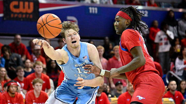 Jan 3, 2026; Dallas, Texas, USA; North Carolina Tar Heels center Henri Veesaar (13) passes the ball by SMU Mustangs center Jaden Toombs (10) during the first half at Moody Coliseum. Mandatory Credit: Jerome Miron-Imagn Images Jan 3, 2026; Dallas, Texas, USA; North Carolina Tar Heels center Henri Veesaar (13) passes the ball by SMU Mustangs center Jaden Toombs (10) during the first half at Moody Coliseum. Mandatory Credit: Jerome Miron-Imagn Images