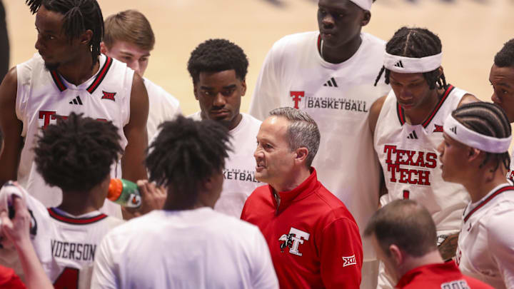 Texas Tech Red Raiders head coach Grant McCasland talks to his team during a timeout during the first half against the West Virginia Mountaineers at Hope Coliseum.