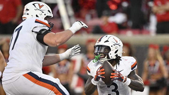 Oct 4, 2025; Louisville, Kentucky, USA; Virginia Cavaliers running back J'Mari Taylor (3) celebrates a touchdown with offensive lineman Noah Josey (77) during the overtime against the Louisville Cardinals at L&N Federal Credit Union Stadium. Virginia defeated Louisville 30-27. Mandatory Credit: Jamie Rhodes-Imagn Images