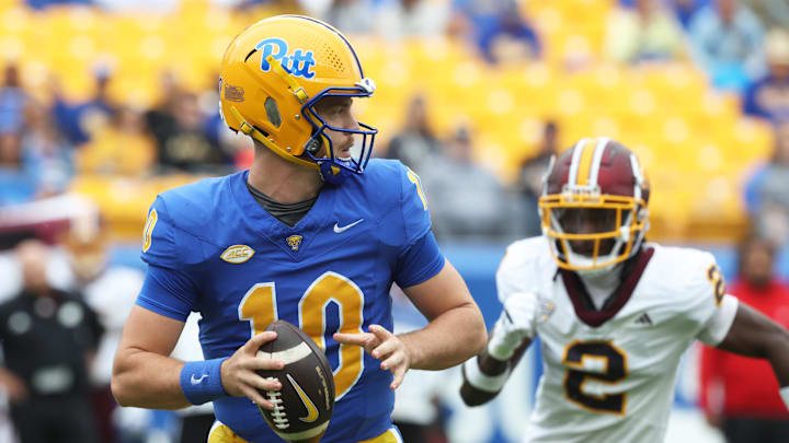 Sep 6, 2025; Pittsburgh, Pennsylvania, USA;  Pittsburgh Panthers quarterback Eli Holstein (10) looks to pass as Central Michigan Chippewas defensive back Elijah Rikard (2) chases during the first quarter at Acrisure Stadium. Mandatory Credit: Charles LeClaire-Imagn Images