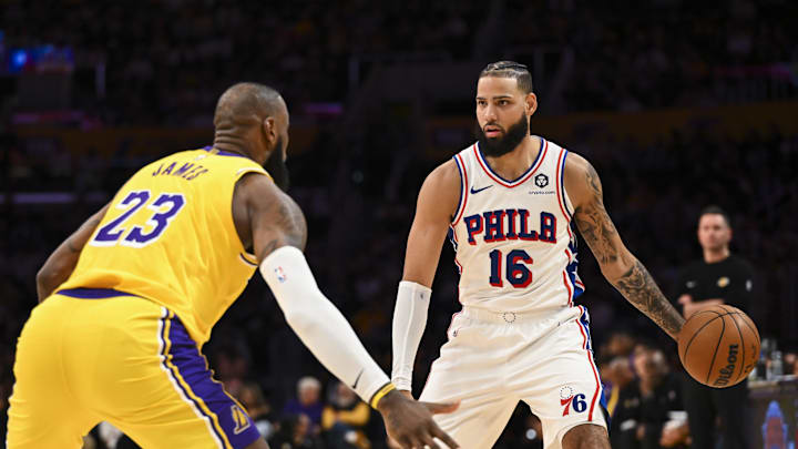 Nov 8, 2024; Los Angeles, California, USA; Philadelphia 76ers forward Caleb Martin (16) looks to pass against Los Angeles Lakers forward LeBron James (23) during the first half at Crypto.com Arena. Mandatory Credit: Jonathan Hui-Imagn Images