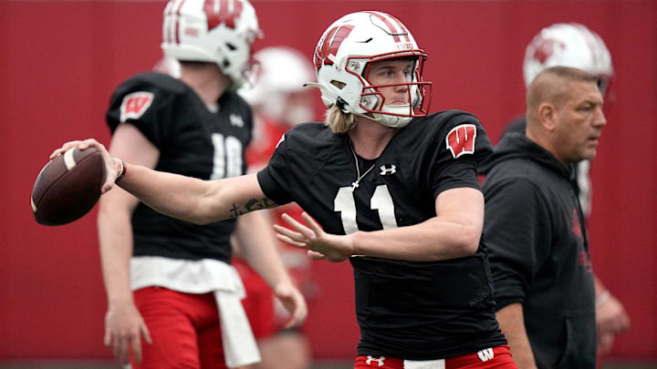 Former Wisconsin quarterback Mabrey Mettauer (11) is shown during spring football practice Thursday, April 25, 2024 in Madison, Wisconsin. He and former offensive coordinator Phil Longo (right) are both now at Sam Houston State.