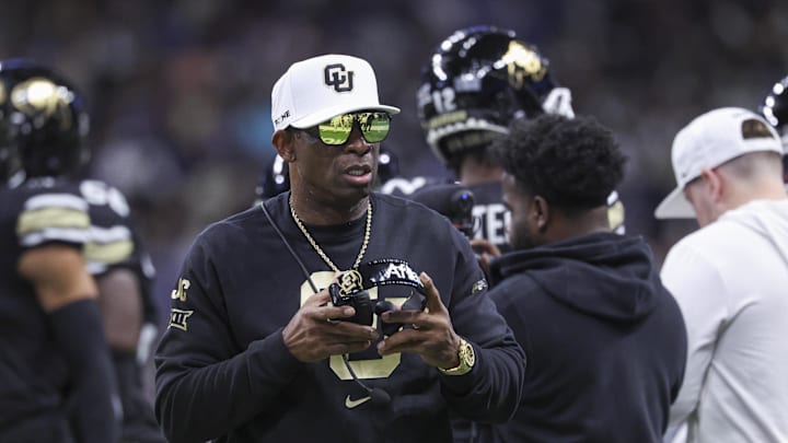 Dec 28, 2024; San Antonio, TX, USA; Colorado Buffaloes head coach Deion Sanders walks on the field between plays during the first quarter against the Brigham Young Cougars at Alamodome. Mandatory Credit: Troy Taormina-Imagn Images