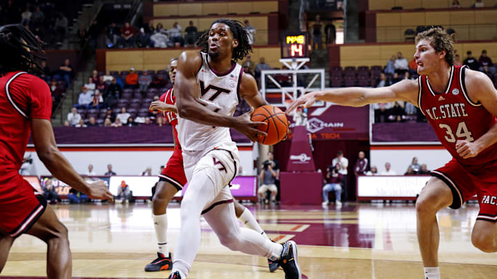 Jan 15, 2025; Blacksburg, Virginia, USA; Virginia Tech Hokies forward Mylyjael Poteat (34) drives to the basket against North Carolina State Wolfpack forward Ben Middlebrooks (34) during the first half at Cassell Coliseum. Mandatory Credit: Peter Casey-Imagn Images