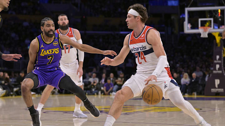 Jan 21, 2025; Los Angeles, California, USA;   Washington Wizards forward Corey Kispert (24) controls the ball past Los Angeles Lakers guard Gabe Vincent (7) in the first half at Crypto.com Arena. Mandatory Credit: Jayne Kamin-Oncea-Imagn Images