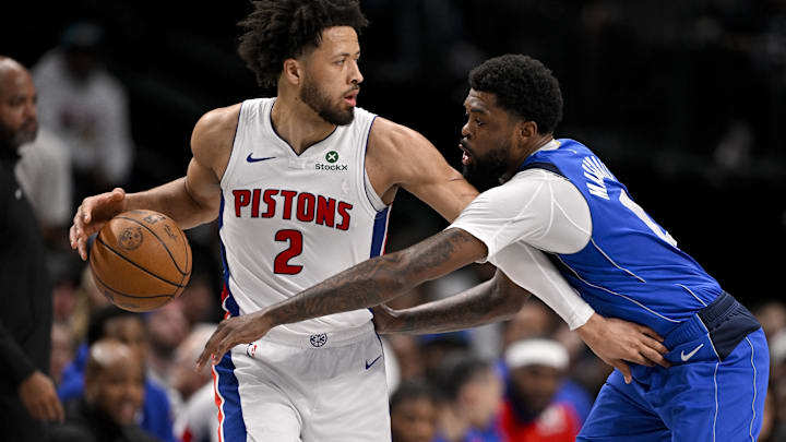 Mar 21, 2025; Dallas, Texas, USA; Detroit Pistons guard Cade Cunningham (2) looks to move the ball past Dallas Mavericks forward Naji Marshall (13) during the first half at the American Airlines Center. Mandatory Credit: Jerome Miron-Imagn Images